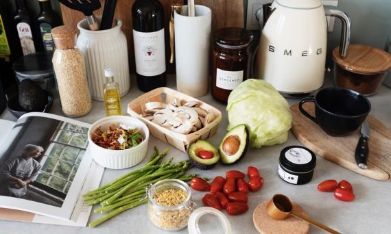 A variety of fresh ingredients and kitchen tools for preparing a healthy meal.
